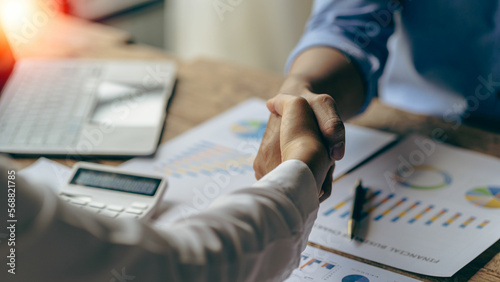 Successful negotiation and handshake concept Two businessmen shake hands with partners to celebrate cooperation and teamwork, mergers and acquisitions. Successful negotiations, business deal concept