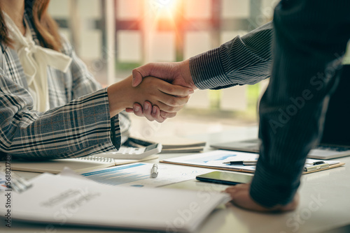Canvas Print Young businessman and businesswoman in investment agreement, two colleague handshake concept