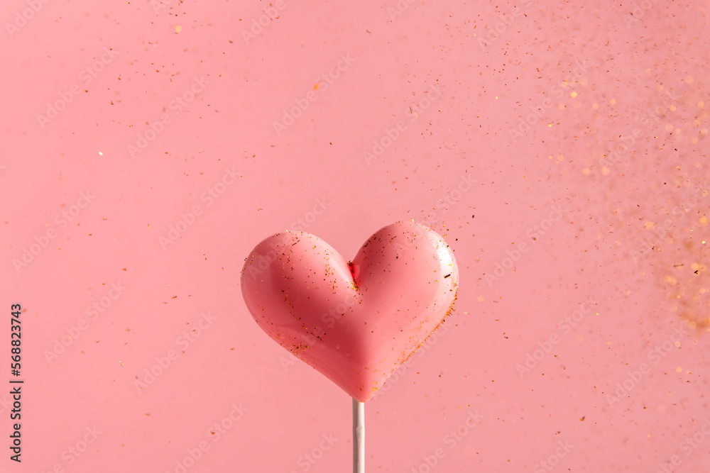 Pink Valentine's day heart shape lollipop candy on empty pastel paper background. Love Concept