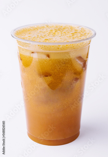 Iced caramel coffee covered with whipped cream in plastic glass