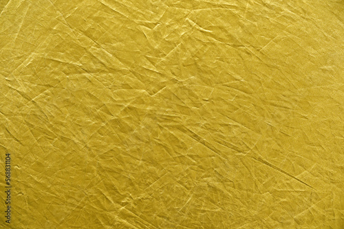 Abstract yellow gold background crumpled fabric.