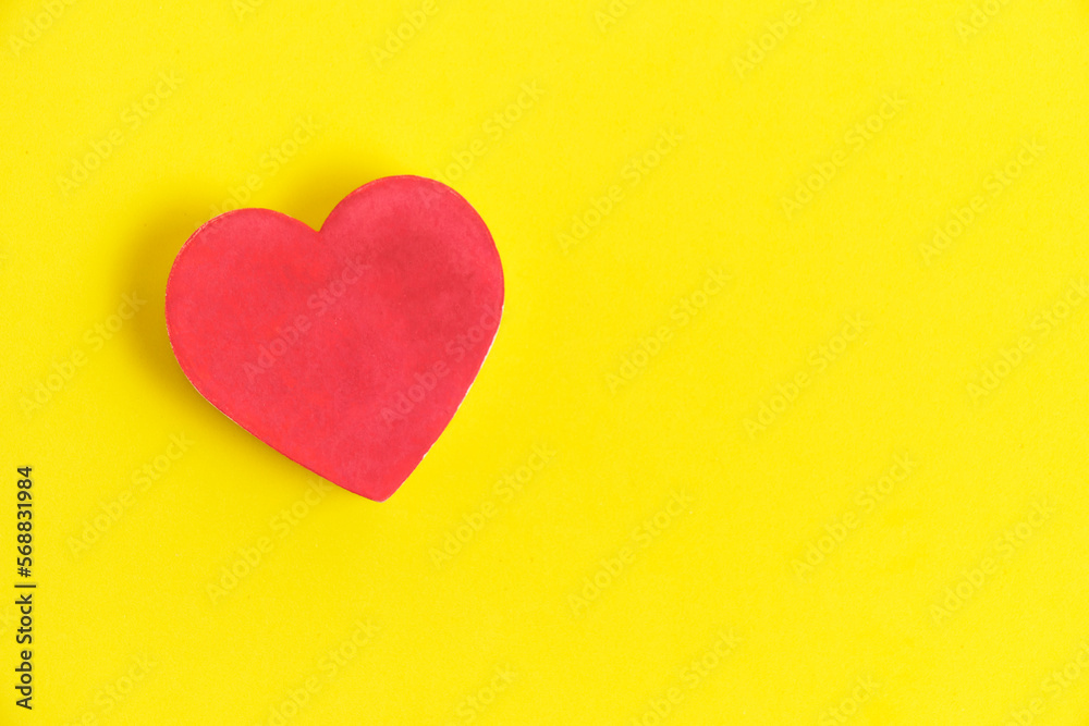 Red heart bright yellow background.