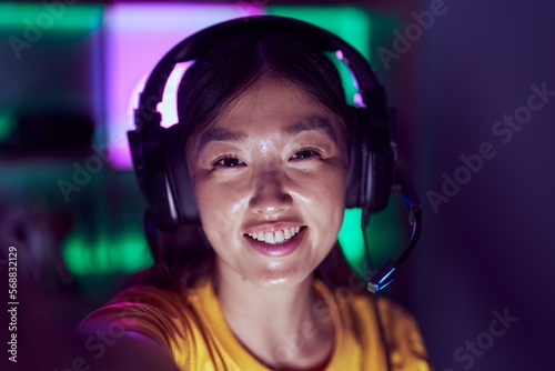 Wallpaper Mural Chinese woman streamer using headset make selfie by camera at gaming room Torontodigital.ca