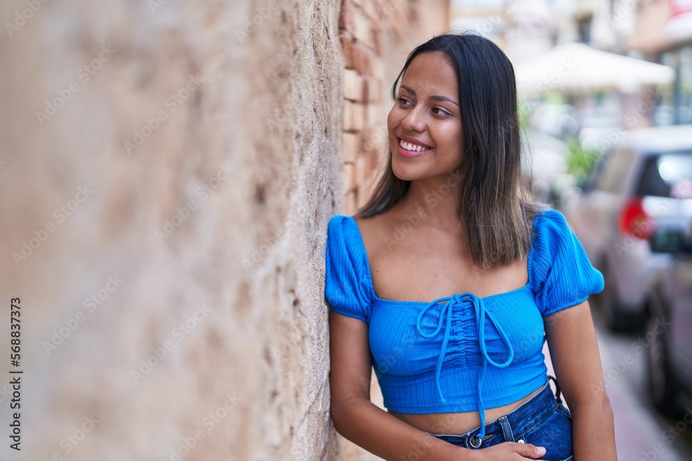 Young hispanic woman smiling confident looking to the side at street Young hispanic woman smiling confident looking to the side at street