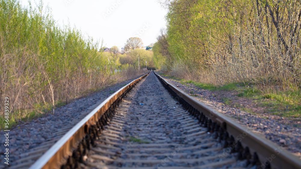 The railroad tracks of the old railway go into the distance.