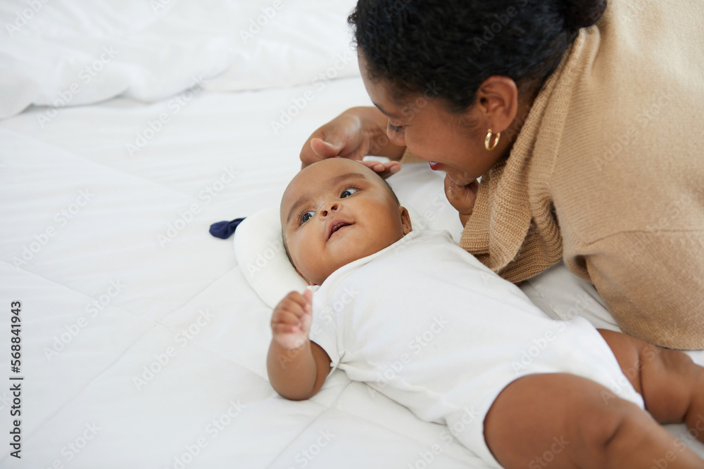 African adorable baby looking mother on bed African adorable baby looking mother on bed