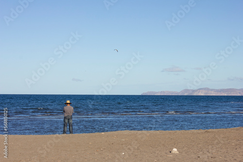 Man at the beach in front of the ocean