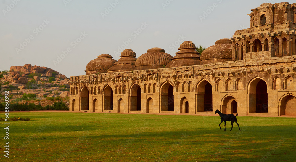 Beautiful view of Indian architecture building elephant stables with meadow and goat