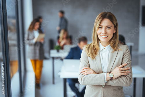 Shot of a confident young businesswoman standing in a modern office. Portrait of a businesswoman standing in the office. One Happy Pretty Business Woman Standing in office