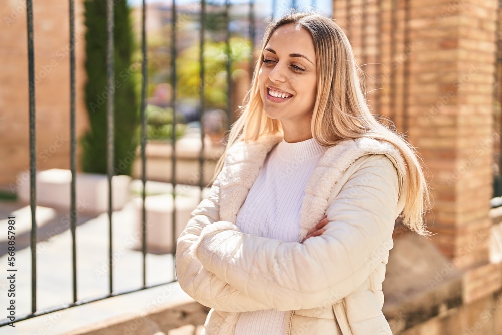 Young woman smiling confident standing with arms crossed gesture at street Young woman smiling confident standing with arms crossed gesture at street