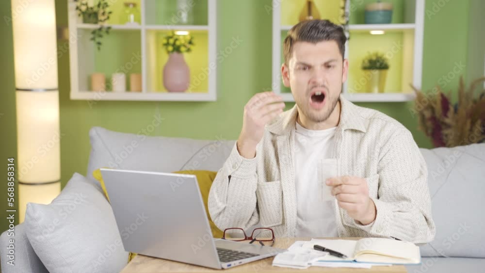 The young man, who makes month-end calculations, starts to get angry when he sees the invoice. The young man, who makes month-end calculations, starts to get angry when he sees the invoice.