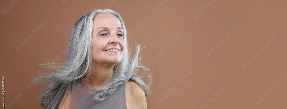 Portrait of smiling senior woman in studio. Portrait of smiling senior woman in studio.