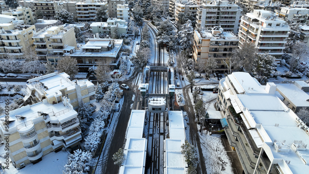 Aerial drone photo of main train station of Marousi centre and district covered in snow as seen at winter, North Athens, Attica, Greece
