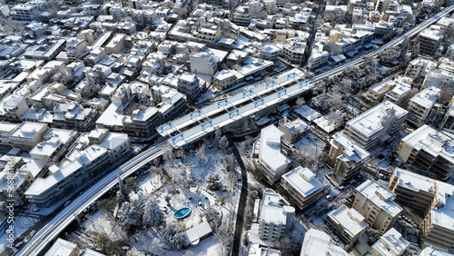 Aerial drone photo of main train station of Marousi centre and district covered in snow as seen at winter  North Athens  Attica  Greece