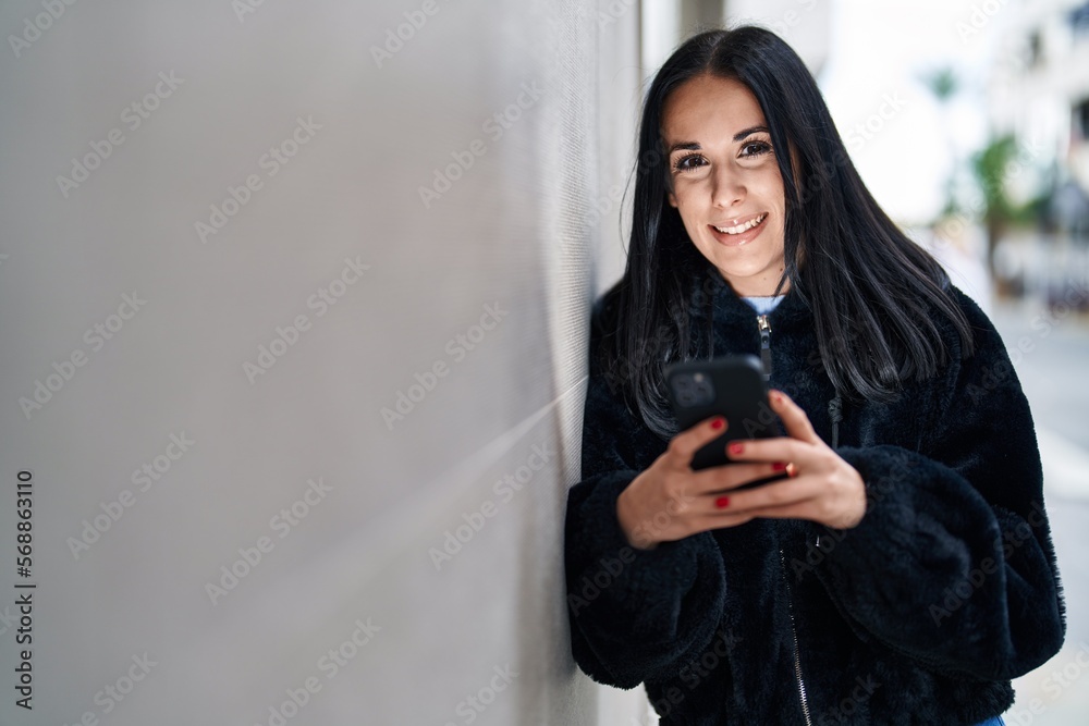 Young caucasian woman smiling confident using smartphone at street