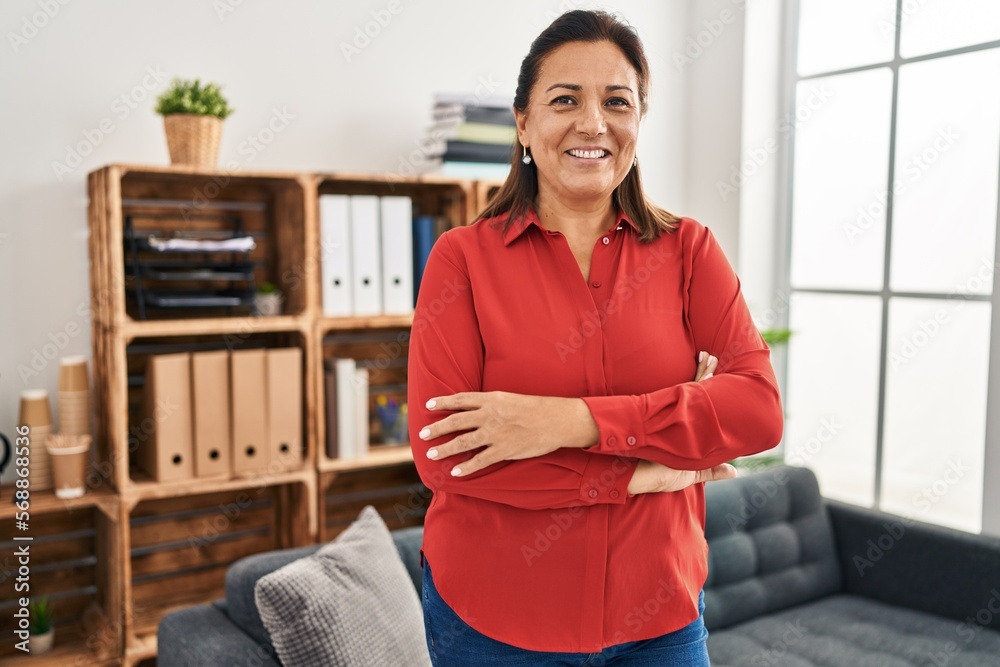 Middle age hispanic woman psychologist standing with arms crossed gesture at psychology center Middle age hispanic woman psychologist standing with arms crossed gesture at psychology center