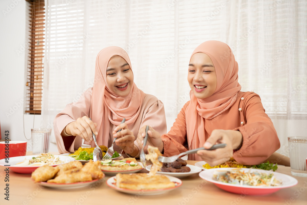 Asian Muslim beautiful woman family making iftar dua to break fasting during Ramadan. Asian Muslim beautiful woman family making iftar dua to break fasting during Ramadan.