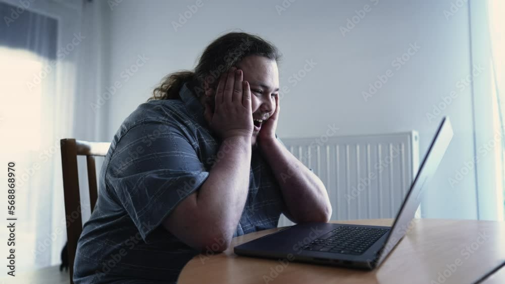 Happy man in front of computer receiving excellent news celebrates. Excited male entrepreneur looking at laptop feeling excitement Happy man in front of computer receiving excellent news celebrates. Excited male entrepreneur looking at laptop feeling excitement