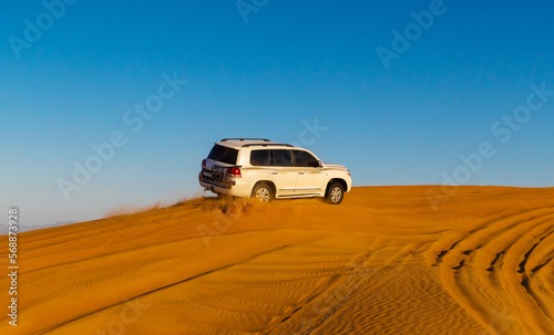 Offroad safari in sand desert, Empty Quarter Desert in United Arab Emirates. Offroader on dunes in Rub’ al Khali desert. Sand and sky.