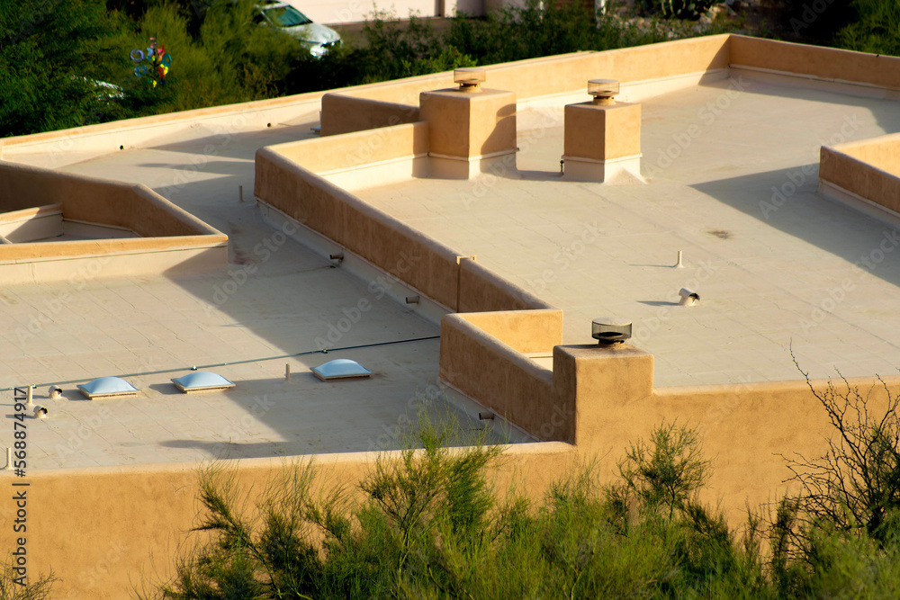 Building rooftop with many skylights and vents with white cement and ...