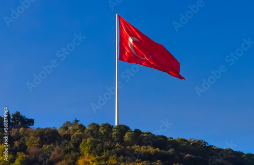 National flag of Turkey flies with the blue sky in the background