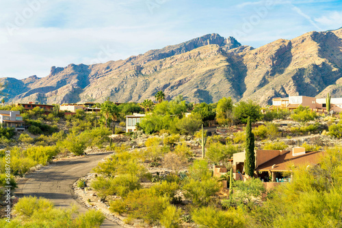 Mansions or houses and homes in the neighborhood in rural parts of arizona with visible street in the hills and moutains