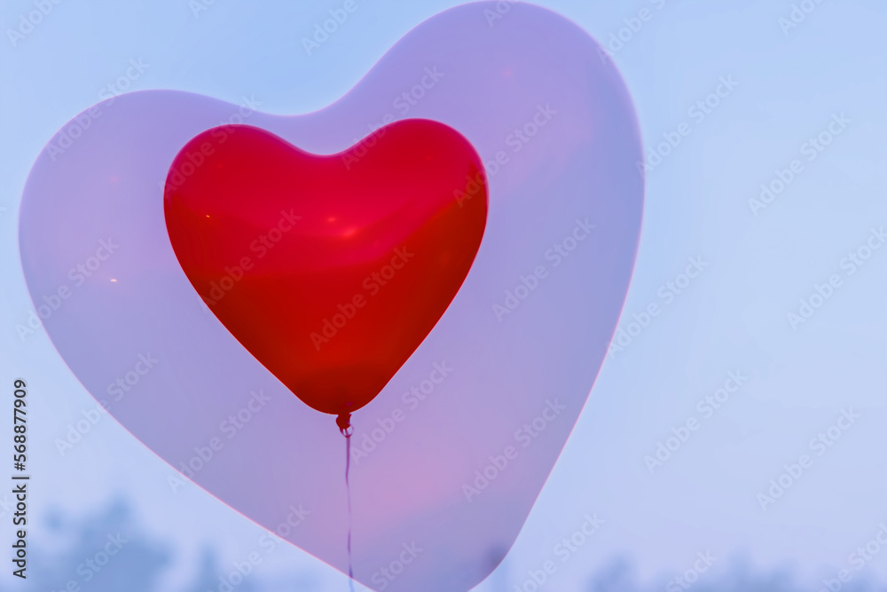 Red LED Balloon in forme Heart and additional silhouette of heart in sky at night. Romantic style love concept, Valentine's holiday