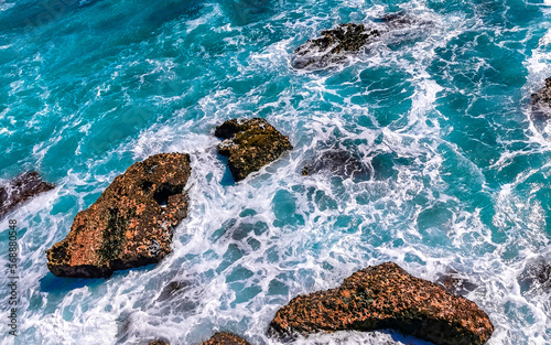 Beautiful rocks cliffs view waves at beach Puerto Escondido Mexico. photo