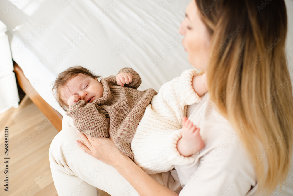 Infant baby try sleep on mother hands in early morning close up top view. Motherhood. Infant baby try sleep on mother hands in early morning close up top view. Motherhood.
