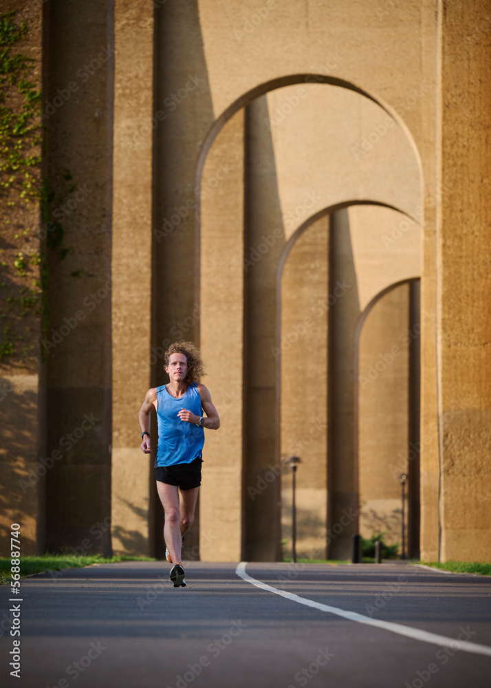 Man jogging under bridge Man jogging under bridge