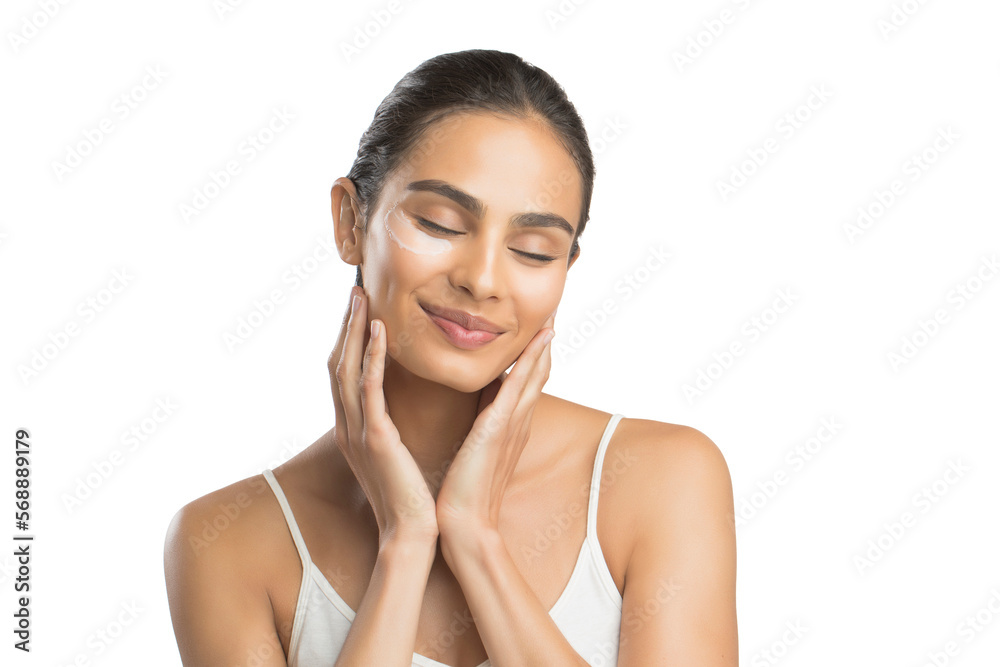 Portrait of smiling young woman applying face cream Portrait of smiling young woman applying face cream