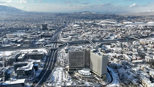 Aerial drone video of snowed ring road in Kifisias and Attiki odos avenues, a popular multilevel junction circular road during winter time, Attica, Greece photo