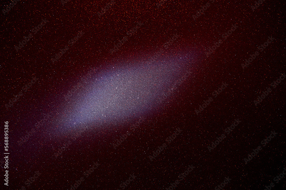 Fototapeta premium On a dark purple fine-grained background, a light purple cloud of light 