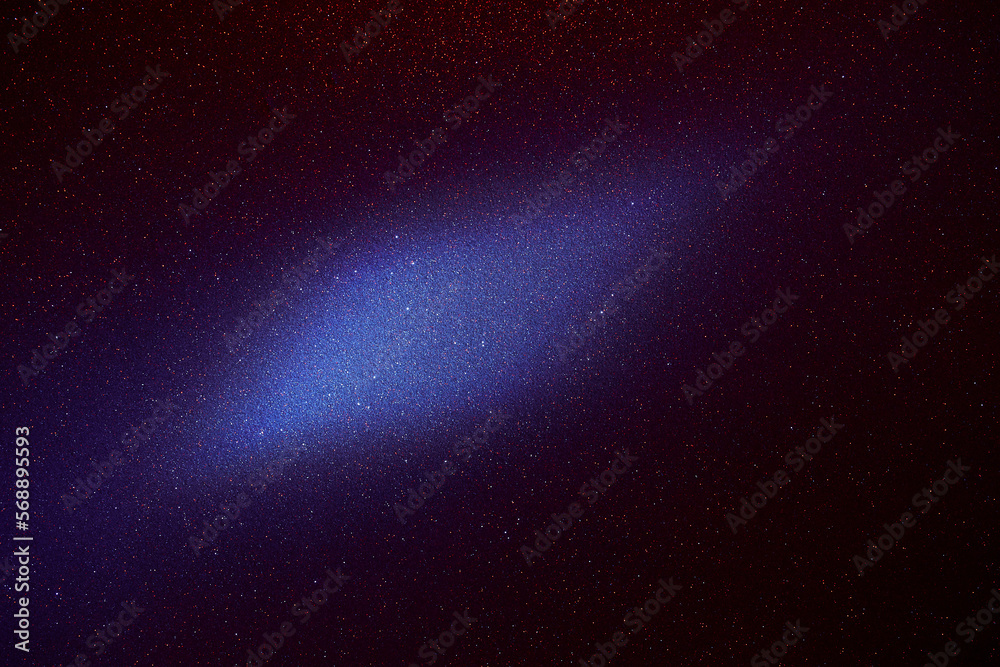 Fototapeta premium On a dark blue fine-grained background, a light blue cloud of light 