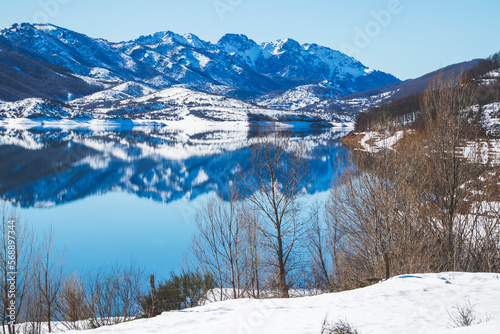 Panoramic view of the Riaño reservoir in the Eastern Mountain of Leon. Sunny day with reflections of the mountains in the water