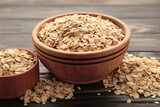 Oatmeal in bowl on brown background. Healthy eating concept.