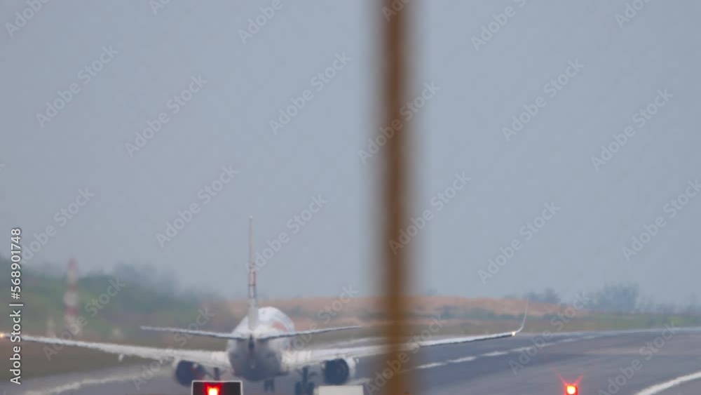 Plane Taking Off Rear View Rear view of a jet passenger plane take off, departure. Runway ...