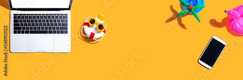 Laptop computer with summer theme items - flat lay