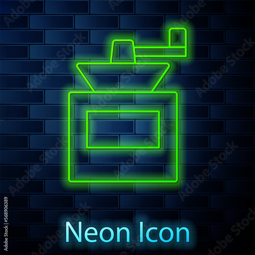 Glowing neon line Manual coffee grinder icon isolated on brick wall background. Vector