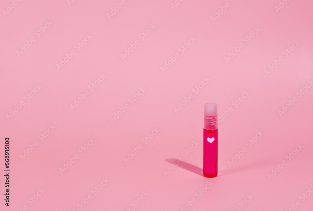 Valentines day lipstick on pink background with the heart on the tube Valentines day lipstick on pink background with the heart on the tube