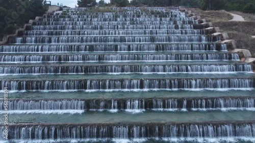 Man made beautiful large waterfall with many stairs.  photo