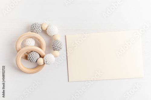 Eco friendly organic newborn teethers and empty card mockup. Template for baby shower invitation, greeting card, branding, logo. Flat lay, top view