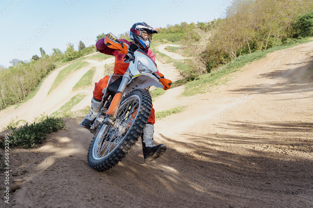 Man riding motorbike on motocross track.Extreme and Adrenaline. Motocross rider in action. Motocross sport. Active lifestyle Man riding motorbike on motocross track.Extreme and Adrenaline. Motocross rider in action. Motocross sport. Active lifestyle