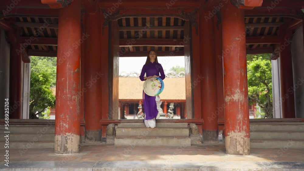 Portrait of Asian Vietnamese woman girl in local temple traveling in Hanoi urban city town, Vietnam. People lifestyle. Portrait of Asian Vietnamese woman girl in local temple traveling in Hanoi urban city town, Vietnam. People lifestyle.