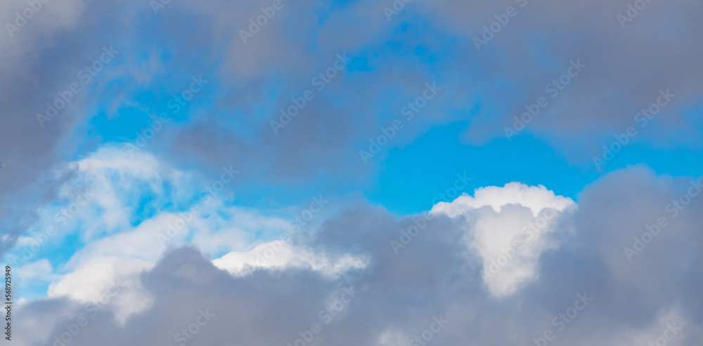 Beautiful huge fluffy clouds on the blue sky. Sky clouds background.