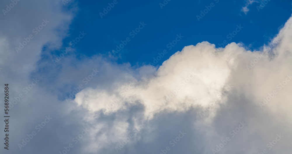 Beautiful huge fluffy clouds on the blue sky. Sky clouds background. Beautiful huge fluffy clouds on the blue sky. Sky clouds background.