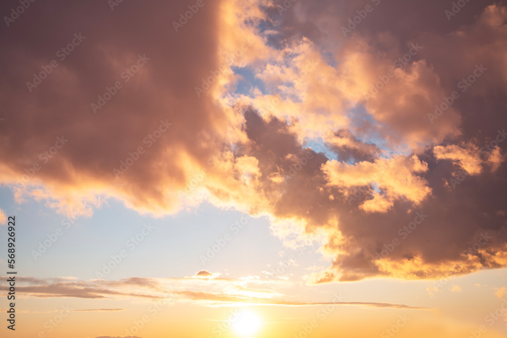 Beautiful orange bright sunset sky with dramatic clouds. Sunset sky background.