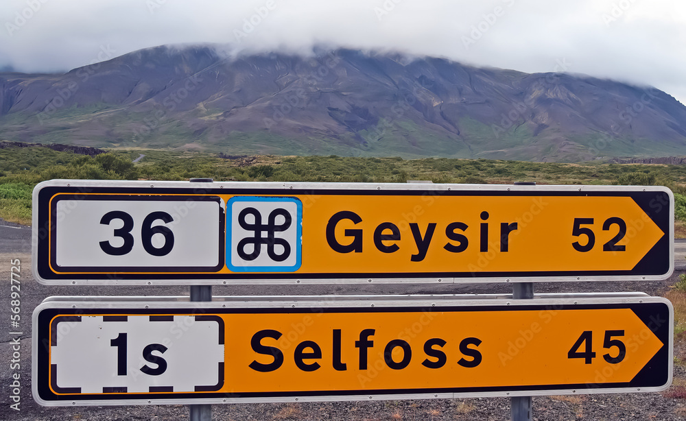 Yellow road signs showing direction and distance to Geysir and town Selfoss - Iceland