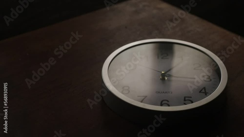 Time concept. Old rustic wall clock on old wooden table with copy space studio shot