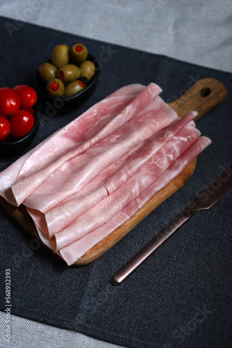 Pork ham slices on a wooden board.